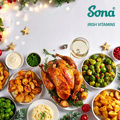 Festive dinner table with roast turkey and rich holiday foods, highlighting heavier meals that may lead to bloating.