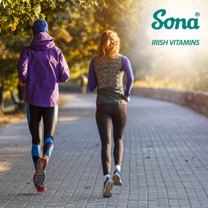 Two people jogging in autumn, symbolising Vitamin B12 support for energy and immunity.