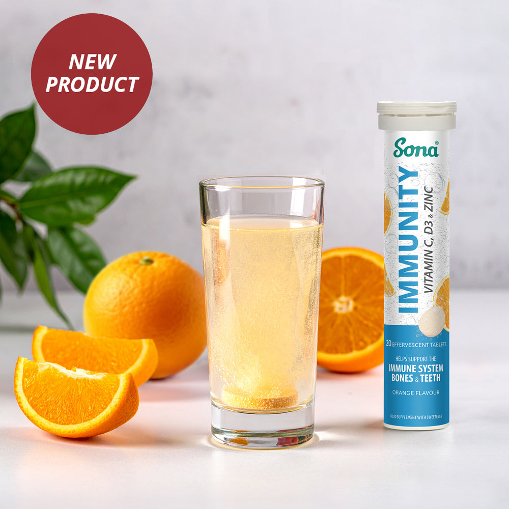 Sona Immunity effervescent supplement tube with a glass of orange juice and oranges on a light background