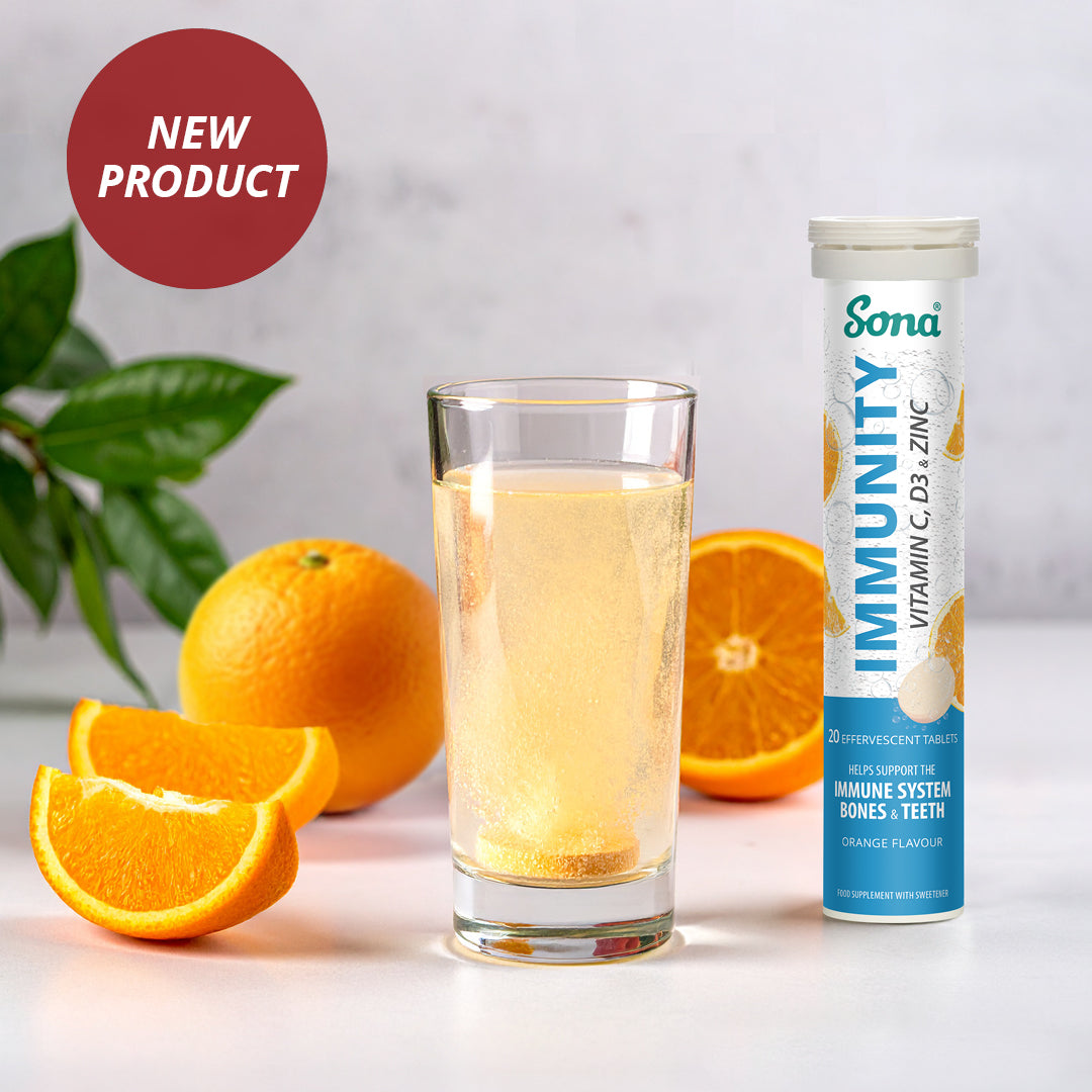 Sona Immunity effervescent supplement tube with a glass of orange juice and oranges on a light background